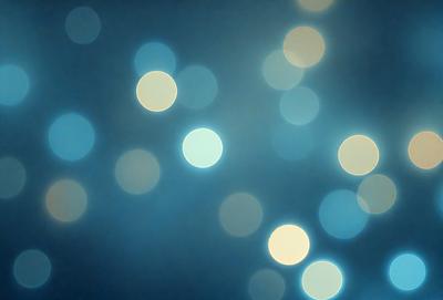 The primary subject of the image is a blue background with a pattern of bright, white lights. The setting appears to be a dark room, and the visual style is a combination of a photo and digital art. The dominant colors are blue and white, creating a calm and serene atmosphere.