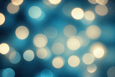 The primary subject of the image is a blue background with a pattern of white lights. The setting appears to be a nighttime cityscape, with the lights creating a vibrant and lively atmosphere. The visual style of the image is a combination of digital art and illustration, as the lights are depicted in a way that resembles a painting or drawing. The colors and mood of the image are predominantly blue and white, with the white lights adding a sense of brightness and energy to the scene.