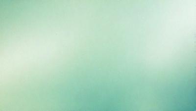 The primary subject of the image is a large, empty, and white wall. The setting is a room with a green background, which creates a contrast with the white wall. The visual style is a simple, clean, and minimalist design. The colors and mood of the image are predominantly green, giving it a calm and serene atmosphere.
