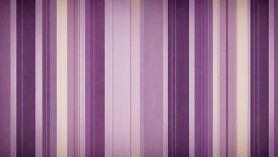 The primary subject of the image is a purple and white striped wallpaper. The setting is a room with a purple and white striped wallpaper covering the walls. The visual style is a patterned wallpaper, which gives the room a unique and colorful appearance. The dominant colors are purple and white, creating a vibrant and lively atmosphere in the room.