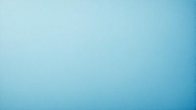 The primary subject of the image is a large, empty blue sky. The setting is a vast, open space with no visible landmarks or objects. The visual style is a natural, outdoor scene with a focus on the sky. The colors and mood are predominantly blue, creating a calm and serene atmosphere.