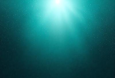 The primary subject of the image is a bright light shining through the water. The light is illuminating the water, creating a beautiful and serene atmosphere. The setting is underwater, with the light coming from above. The visual style of the image is a combination of photo and digital art, creating a stunning and realistic representation of the underwater environment. The colors and mood of the image are predominantly blue, with the light creating a sense of tranquility and wonder.