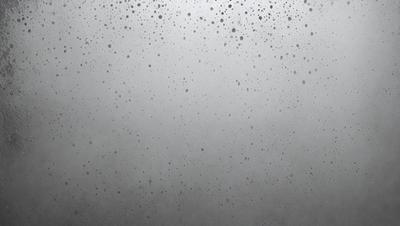 The primary subject of the image is a gray, foggy sky with a few white specks. The setting is a cloudy day, and the visual style is a photo. The colors and mood of the image are predominantly gray and foggy, creating a somewhat moody atmosphere.