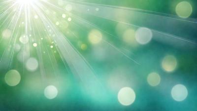 The primary subject of the image is a bright light source, possibly a sun or a light bulb, shining through a green background. The light source creates a vibrant and lively atmosphere. The setting is a green background, which adds a sense of freshness and naturalness to the scene. The visual style of the image is a combination of photo and digital art, as it captures the light source's rays and the green background in a visually appealing manner. The colors and mood of the image are pre