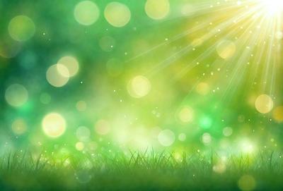 The primary subject of the image is a lush green field with bright sunlight shining through it. The setting is a natural environment, with the sunlight creating a warm and inviting atmosphere. The visual style of the image is a photo, capturing the vibrant colors and natural beauty of the field. The colors and mood of the image are predominantly green, with the sunlight adding a touch of warmth and brightness to the scene.