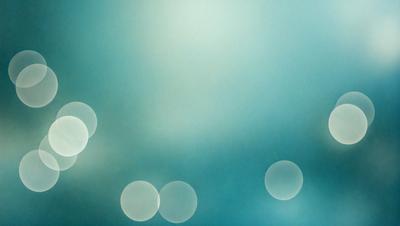 The primary subject of the image is a blue sky with a few white dots scattered throughout. The setting is a cloudy day, and the visual style appears to be a photo. The colors and mood of the image are predominantly blue and calm, creating a serene atmosphere.