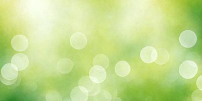 The primary subject of the image is a green background with a few yellow circles. The setting appears to be a natural environment, possibly a forest or a park. The visual style of the image is a combination of a photo and a painting, creating a unique and artistic effect. The colors and mood of the image are predominantly green and yellow, giving it a warm and inviting atmosphere.