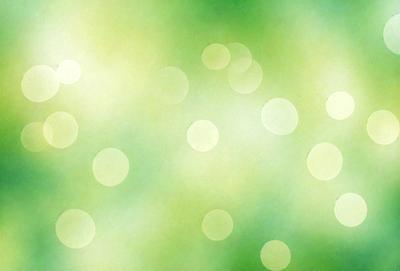 The primary subject of the image is a close-up of a green background with a pattern of circles. The setting appears to be a green field, and the visual style is a combination of a photo and digital art. The dominant colors are green and white, creating a calm and serene atmosphere.