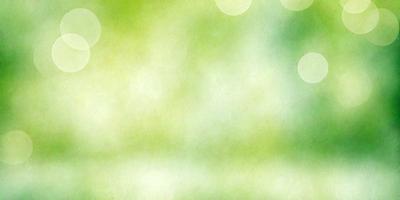 The primary subject of the image is a green background with a few white dots. The setting is a natural environment, possibly a forest or a park. The visual style is a combination of a photo and a digital art, creating a unique and artistic appearance. The colors are predominantly green and white, giving the image a calm and serene atmosphere.