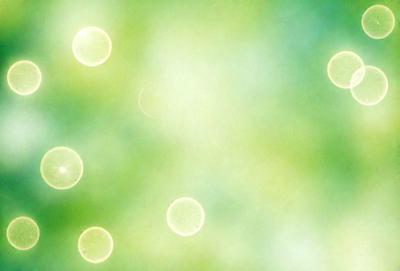 The primary subject of the image is a close-up of a green background with a pattern of yellow and white circles. The setting appears to be a bright and lively environment, possibly a garden or an outdoor space. The visual style of the image is a combination of a photo and a digital art, creating a unique and vibrant atmosphere. The dominant colors in the image are green, yellow, and white, which contribute to a cheerful and lively mood.