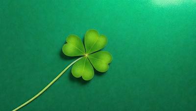 The primary subject of the image is a green four-leaf clover, which is placed on a green background. The visual style of the image is a photo, and the colors and mood are predominantly green, creating a calm and serene atmosphere.
