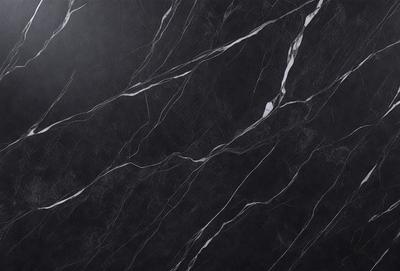 The primary subject of the image is a black marble countertop. The setting is a kitchen, with the countertop being the main focus of the scene. The visual style is a close-up of the marble countertop, showcasing its texture and pattern. The colors and mood of the image are predominantly dark, with the black marble providing a striking contrast against the surrounding environment.