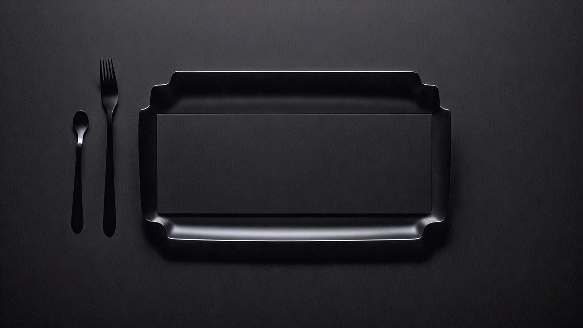 The primary subject of the image is a black tray or container. The setting is a black background, which creates a contrast with the tray. The visual style is a close-up of the tray, showcasing its details. The colors and mood of the image are dark and moody, with the black tray being the main focus.