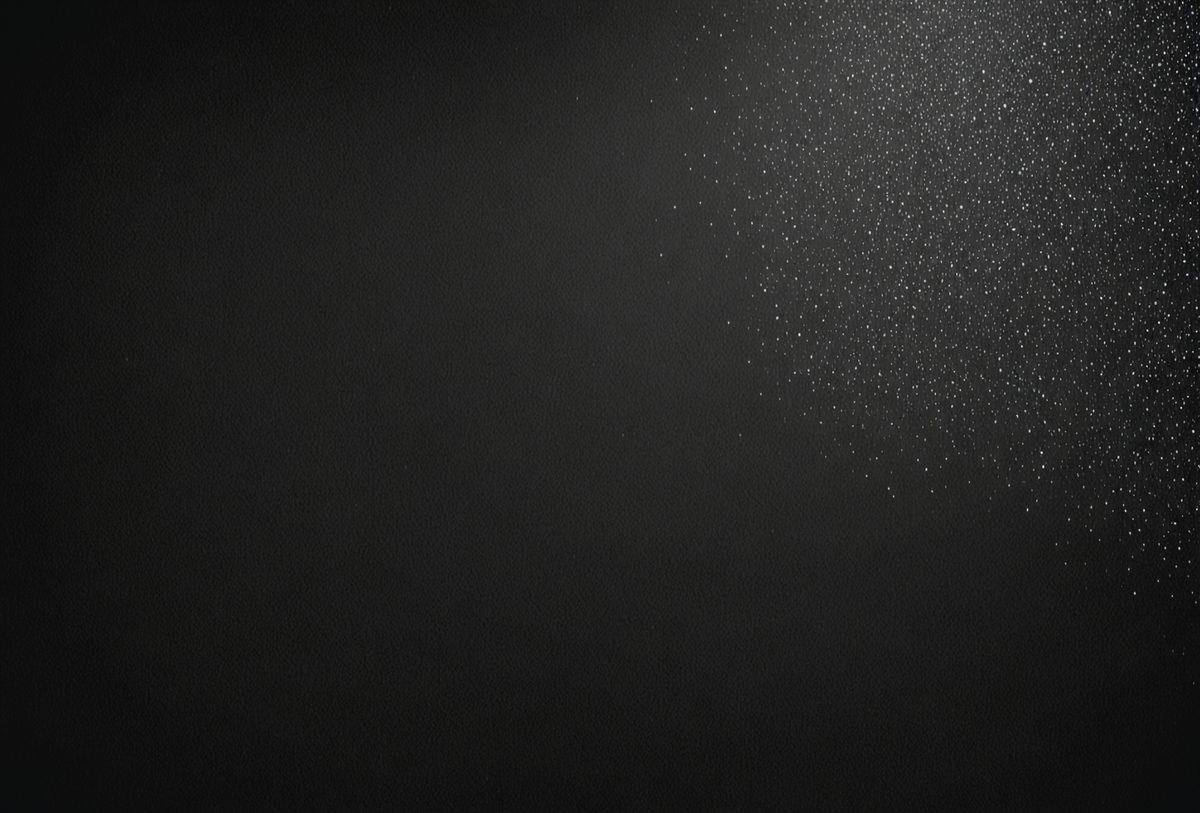 The primary subject of the image is a black background with a white light source. The setting is a dark room, and the visual style is a black and white photo. The dominant colors are black and white, creating a moody atmosphere.