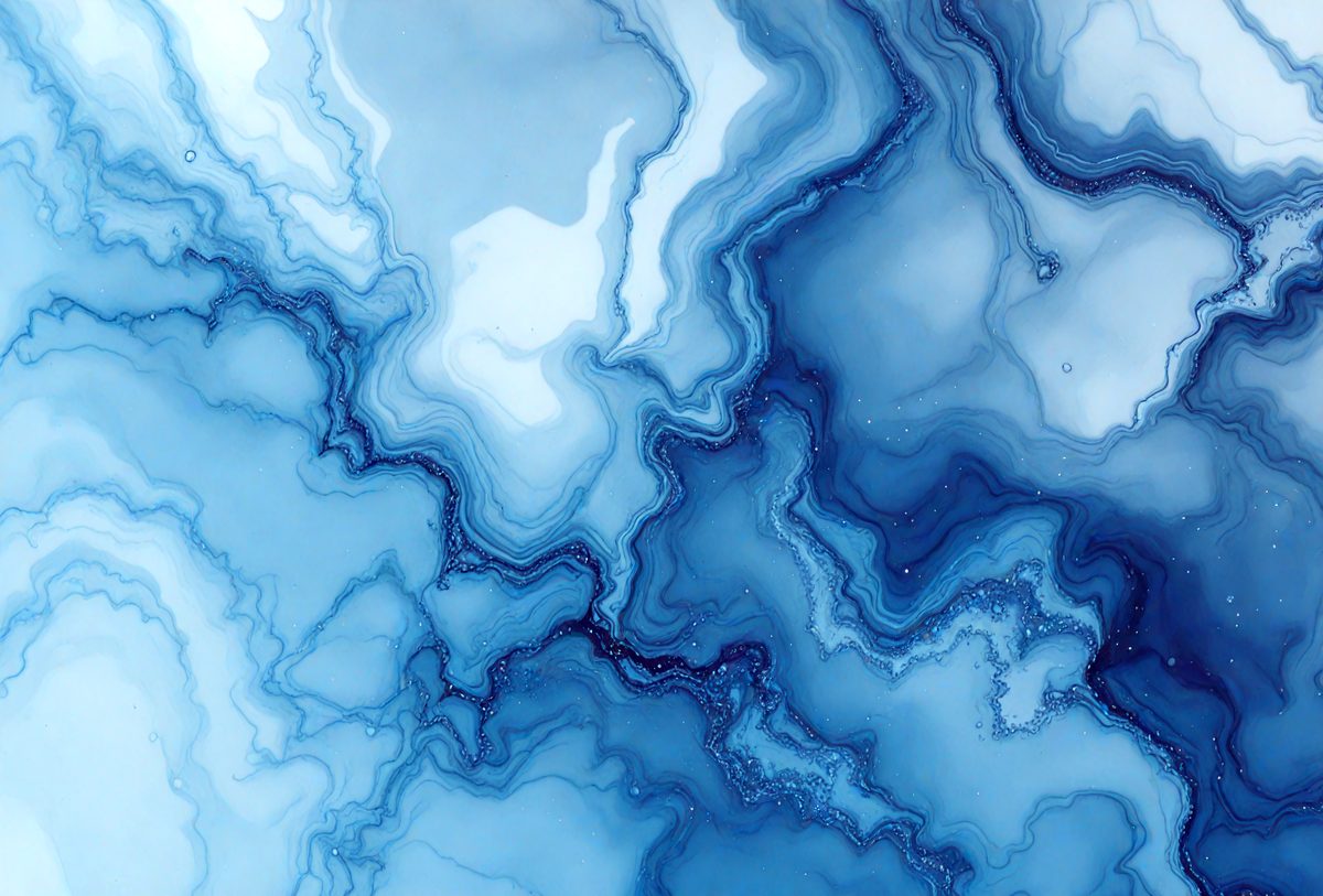 The primary subject of the image is a blue and white marbled pattern, which is the main object, scene, or focus of the image. The setting or background is a blue and white marbled surface, which is visible. The visual style of the image is a photo, as it is a real-life photograph of the marbled surface. The dominant colors in the image are blue and white, creating a calm and serene atmosphere.
