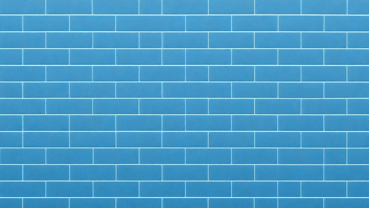 The primary subject of the image is a blue brick wall. The setting is a room with a blue brick wall as the main focus. The visual style is a photo of the blue brick wall. The dominant colors are blue and white, creating a calm and soothing atmosphere.