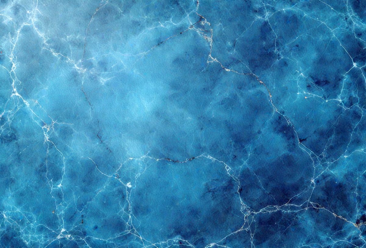 The primary subject of the image is a blue and white marbled surface, which appears to be a wall or a piece of art. The setting is a room with a blue and white marbled wall, and the visual style is a close-up of the marbled surface. The colors and mood of the image are predominantly blue and white, creating a calm and serene atmosphere.