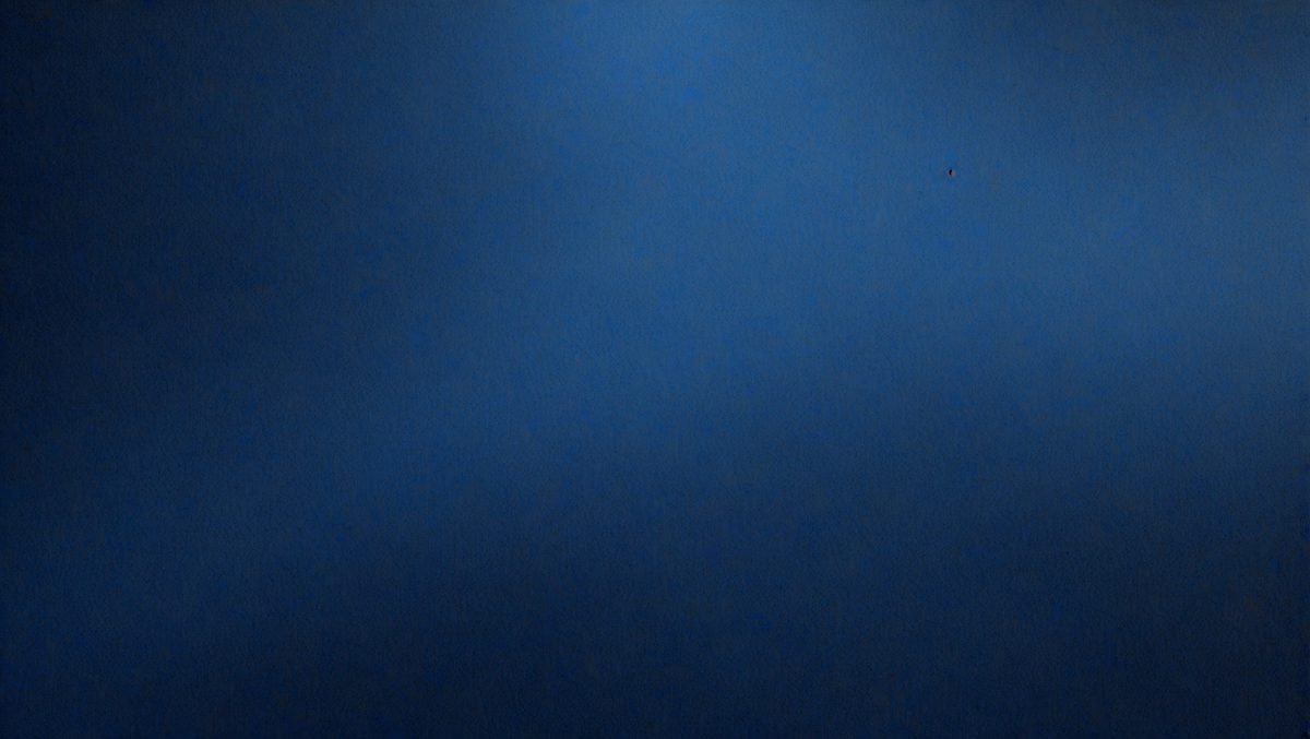 The primary subject of the image is a blue sky with no clouds. The setting is a clear, cloudless day. The visual style is a photo of the sky, showcasing the vastness and beauty of the open sky. The colors and mood are predominantly blue, creating a serene and peaceful atmosphere.