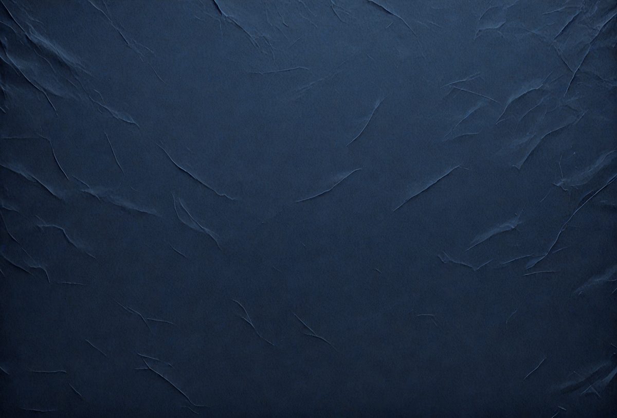 The primary subject of the image is a blue wall with a textured surface. The setting is a room with a blue background. The visual style is a close-up of the blue wall, which gives a sense of depth and texture. The colors and mood of the image are predominantly blue, creating a calm and serene atmosphere.