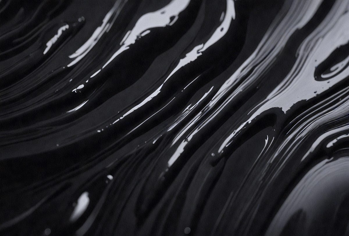 The primary subject of the image is a close-up of a black, swirling liquid, possibly a dark substance or a patterned surface. The setting is a black background, which contrasts with the swirling liquid. The visual style appears to be a close-up of a pattern or a texture, creating a moody and intriguing atmosphere.