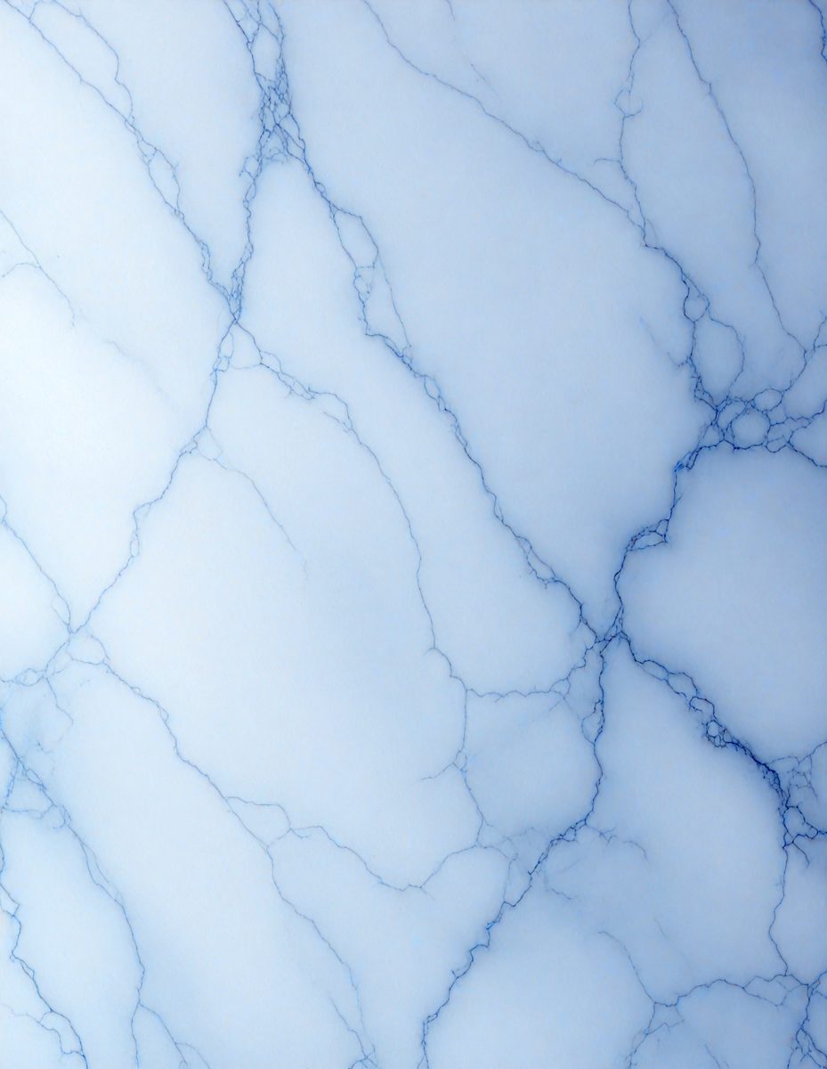 The primary subject of the image is a close-up of a marble-like surface, possibly a wall or a countertop. The setting is a room with a blue-gray color scheme, which gives the space a modern and sophisticated appearance. The visual style is a close-up of the marble-like surface, showcasing its intricate patterns and textures. The colors and mood of the image are predominantly blue and gray, creating a calm and elegant atmosphere.