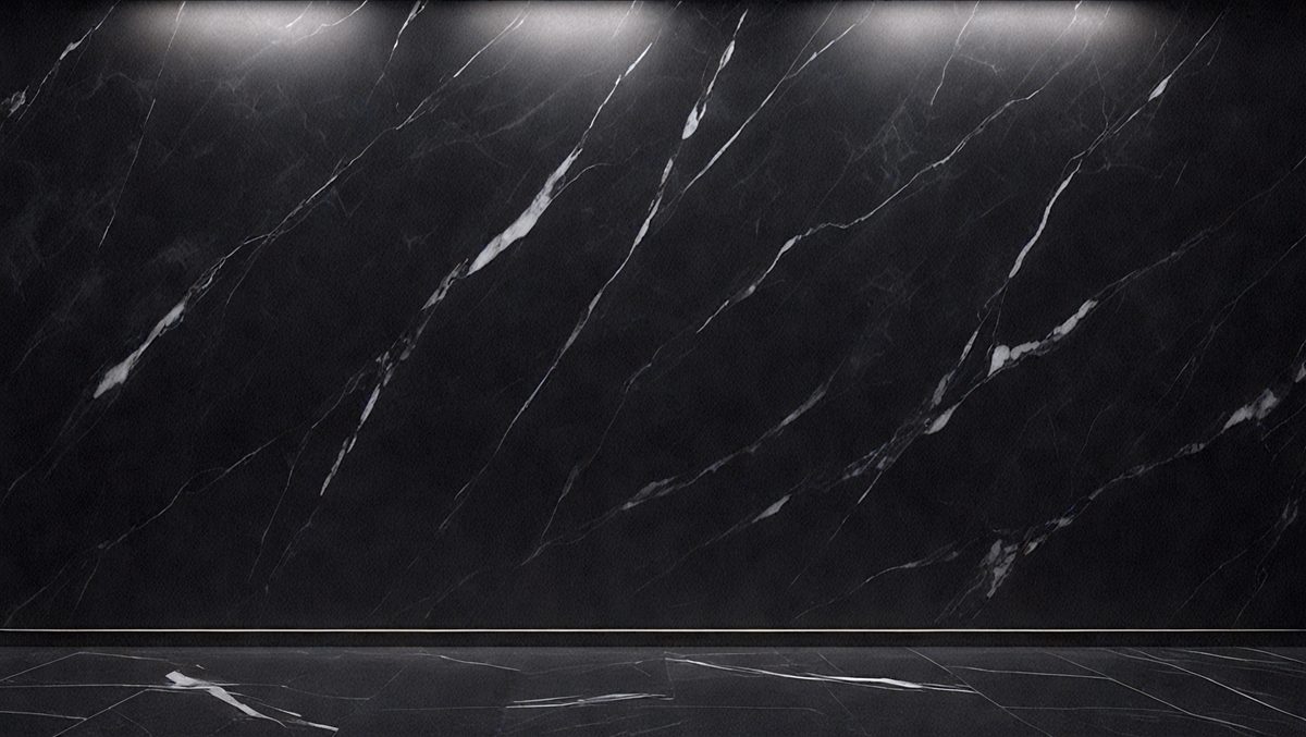 The primary subject of the image is a black marble wall with a pattern of white and grey veins. The setting is a room with a black marble floor, and the visual style is a close-up of the marble wall. The colors and mood of the image are dark and dramatic, with the black marble creating a striking contrast against the white and grey veins.