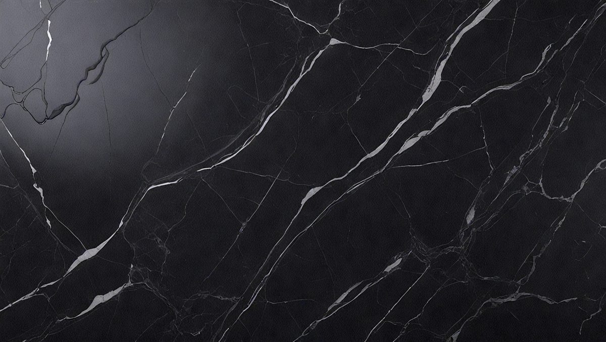 The primary subject of the image is a black marble countertop. The setting is a kitchen, with the countertop being the main focus of the scene. The visual style is a close-up of the marble countertop, showcasing its texture and pattern. The colors and mood of the image are predominantly dark, with the black marble countertop being the main source of contrast.