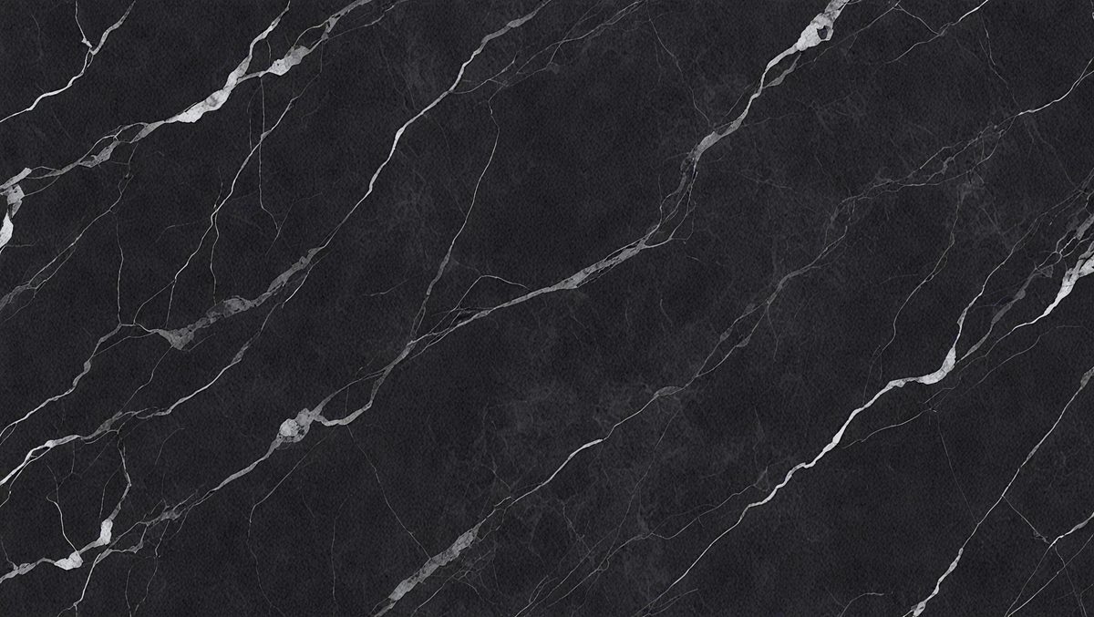 The primary subject of the image is a black marble countertop. The setting is a kitchen, with the countertop being the main focus of the scene. The visual style is a close-up of the marble countertop, showcasing its texture and pattern. The colors and mood of the image are predominantly dark, with the black marble countertop being the main source of contrast.