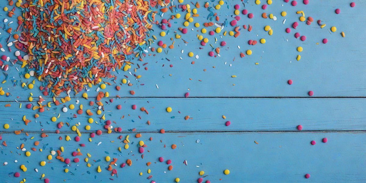 freepik__colorful-sprinkles-scattered-on-a-cadet-blue-paint__25008_250923220008_00001.png